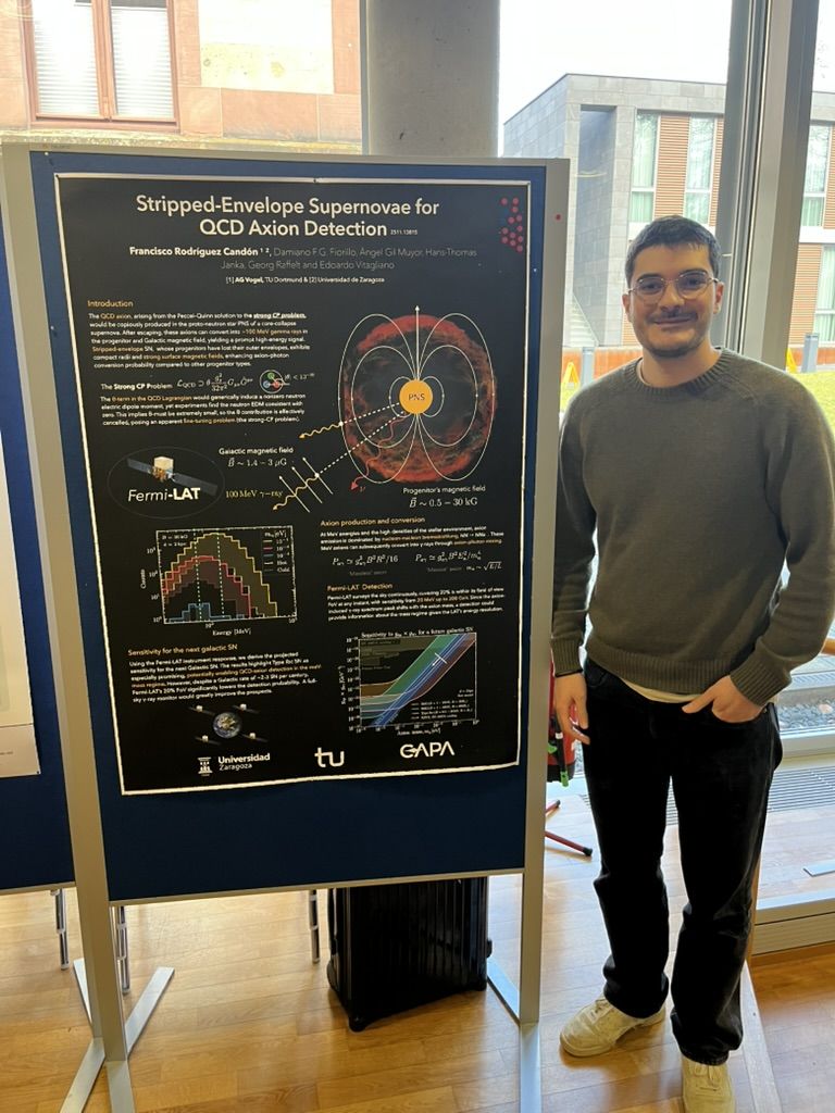 Francisco next to his poster on stripped-envelope supernovae for QCD axion detection