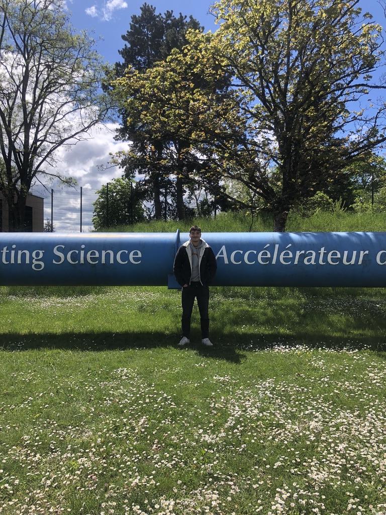 Francisco in front of the Accelerating Science pipe sculpture at CERN
